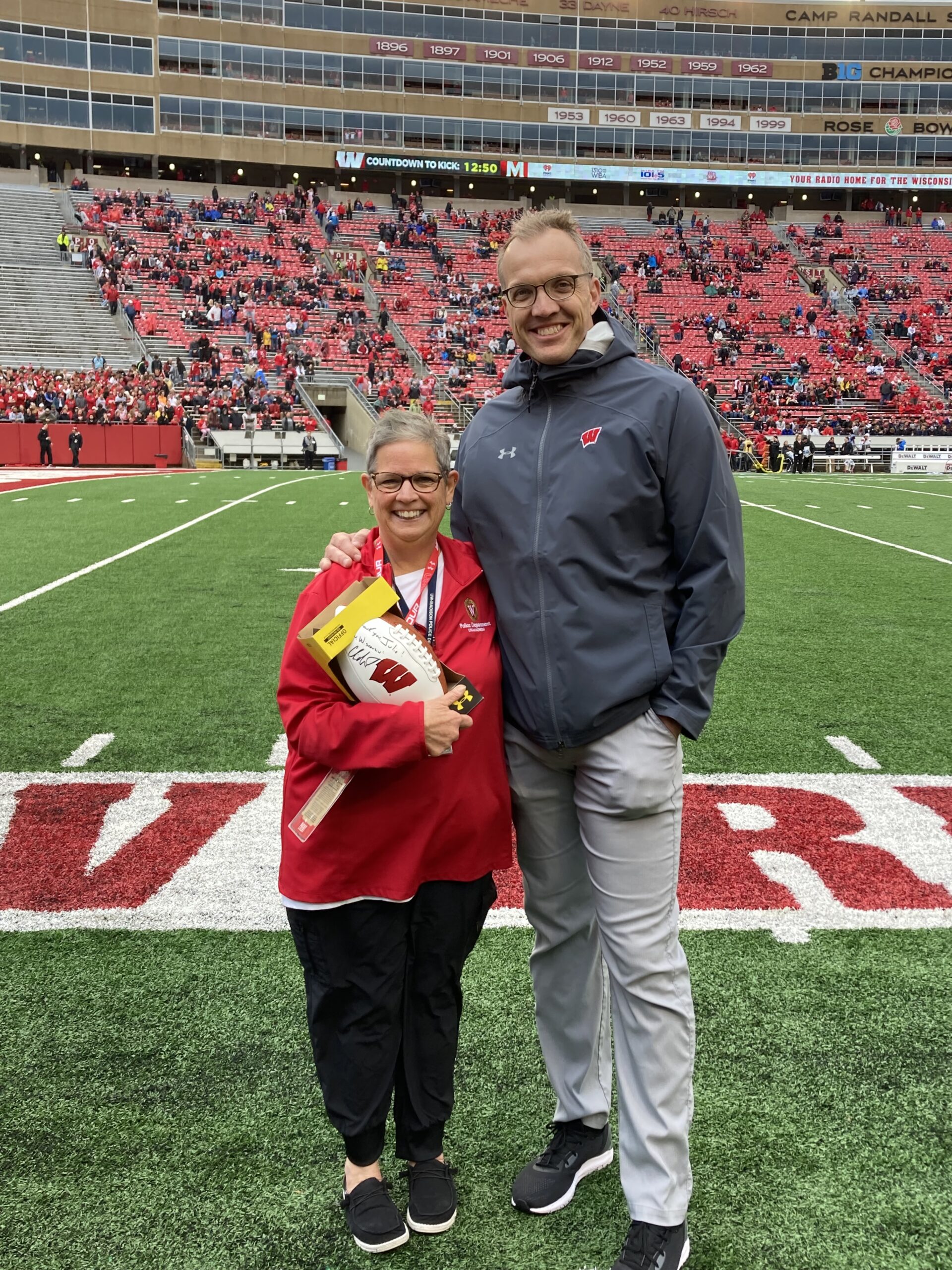 UW-Madison Director of Athletics Chris McIntosh presented a signed football to Julie Dahmen as a token of appreciation for her 41+ years of service to UW-Madison.