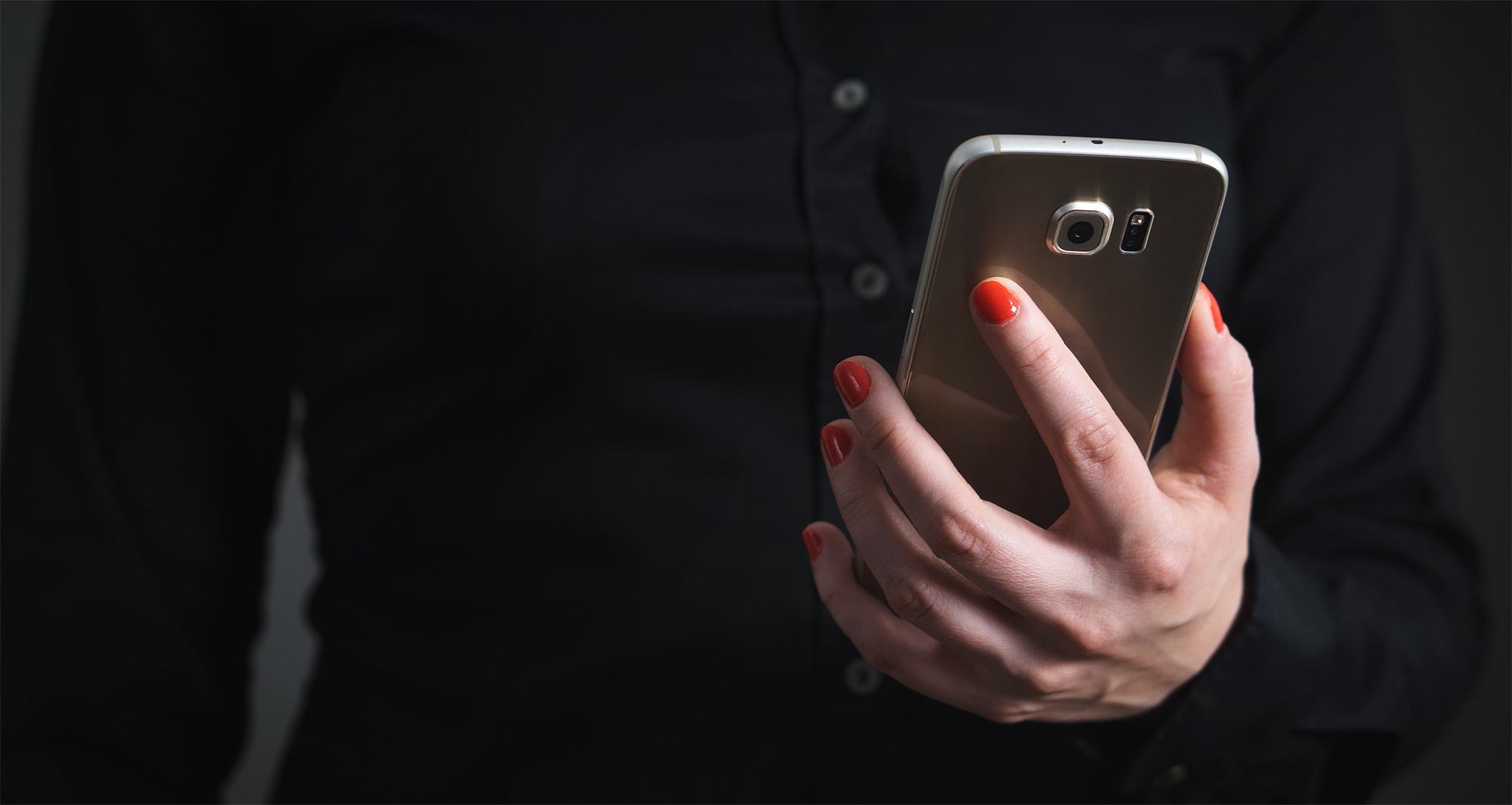 Close up of a business person looking at mobile phone with blurred 