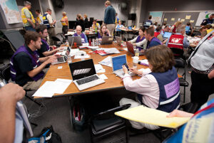 Numerous designated staff attend to a full-scale campus emergency response exercise in the Emergency Operation Center.