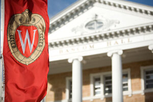 A W banner hangs in front of Bascom Hall.