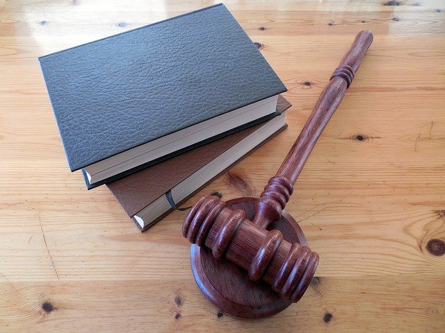 Photo of a gavel next to law books.